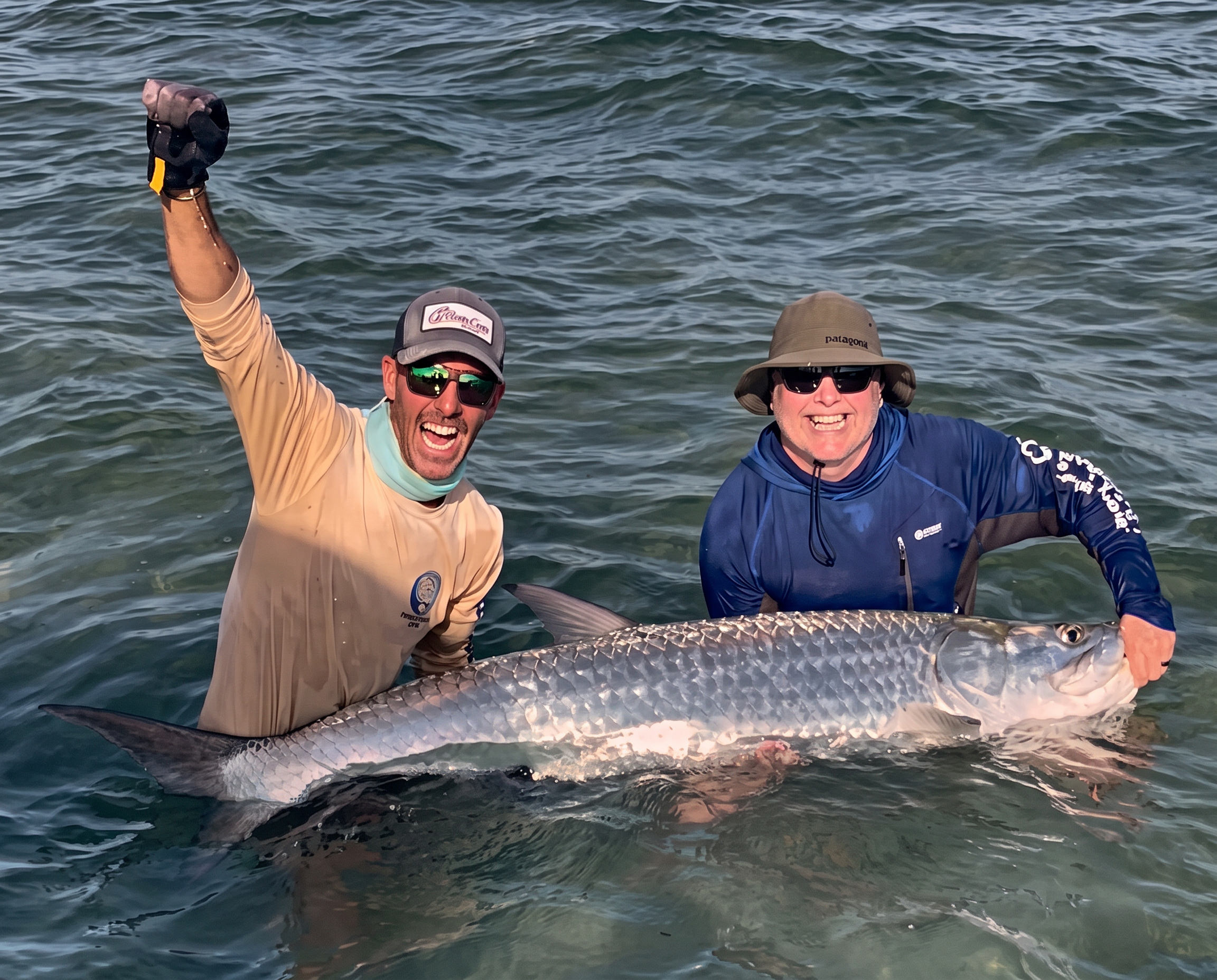 Captain and guest holding a tarpon upright in the Key West shallows