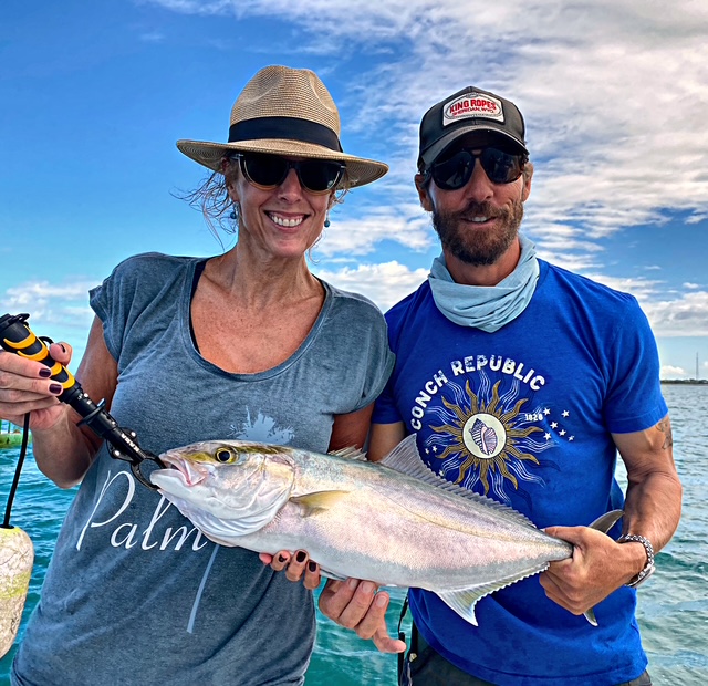 Couple holding an amberjack on a Key West charter