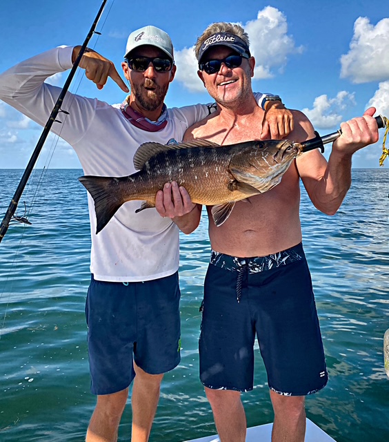 Two anglers with a snapper on a Key West backcountry charter