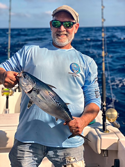Angler holding a blackfin tuna on a Key West charter