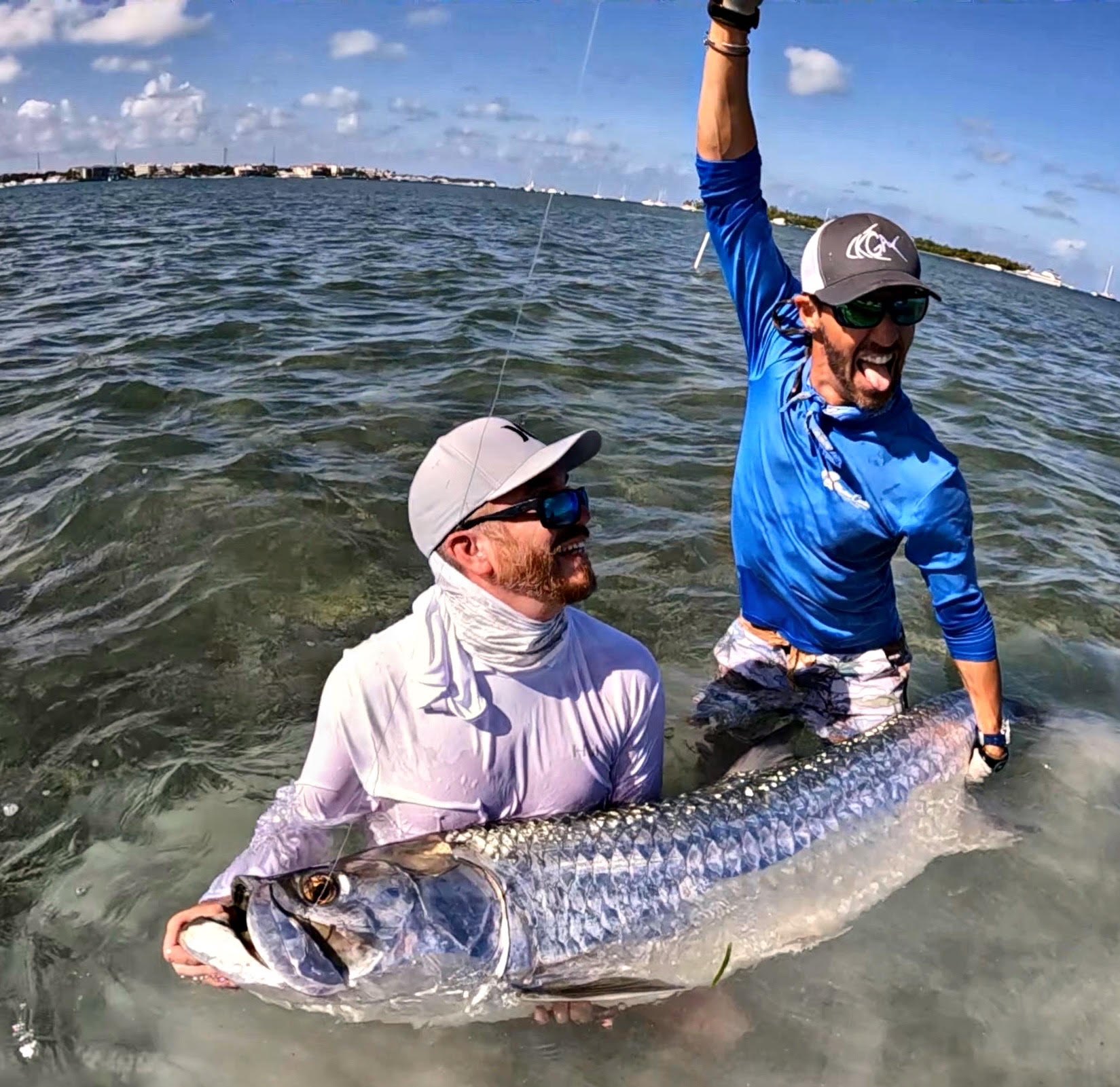 Angler and captain holding a large tarpon before release on a full day Key West charter