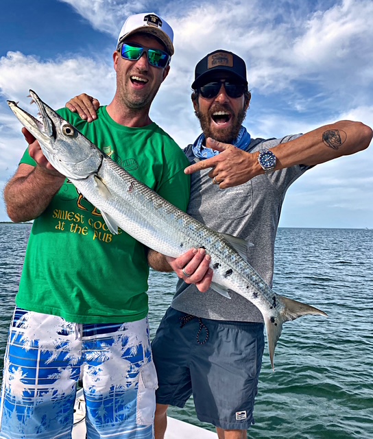 Two friends holding a long barracuda off Key West