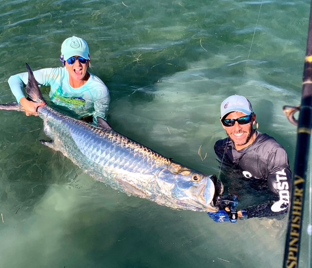 Captain and guest holding a tarpon in the shallows off Key West