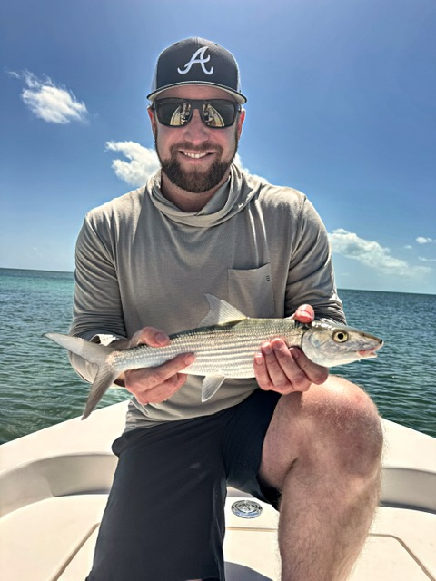 Angler holding a bonefish on the bow off Key West
