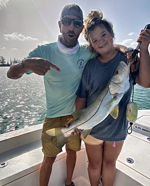 Young angler and captain with a snook in Key West