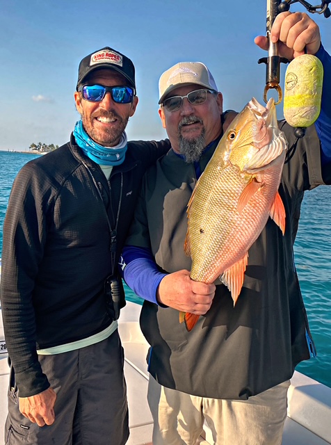 Two anglers with a mutton snapper at the Key West marina