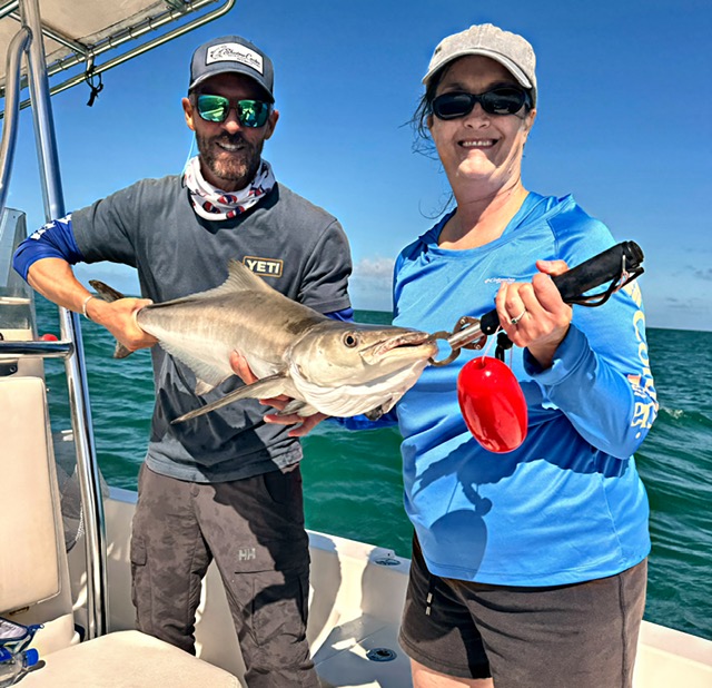 Captain and guest holding a cobia off Key West