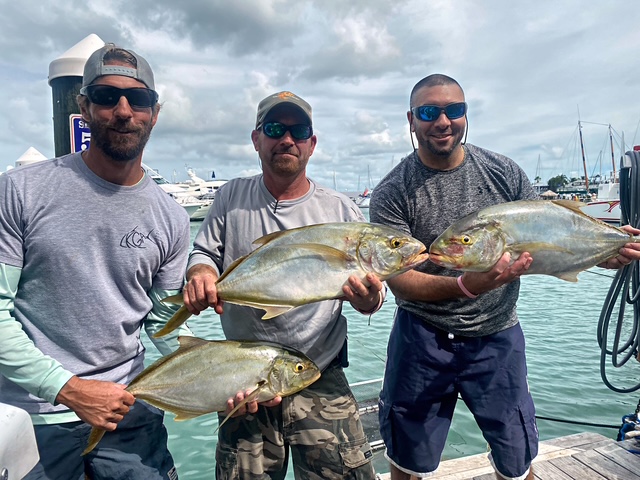 Three anglers with jack crevalle at the Key West marina