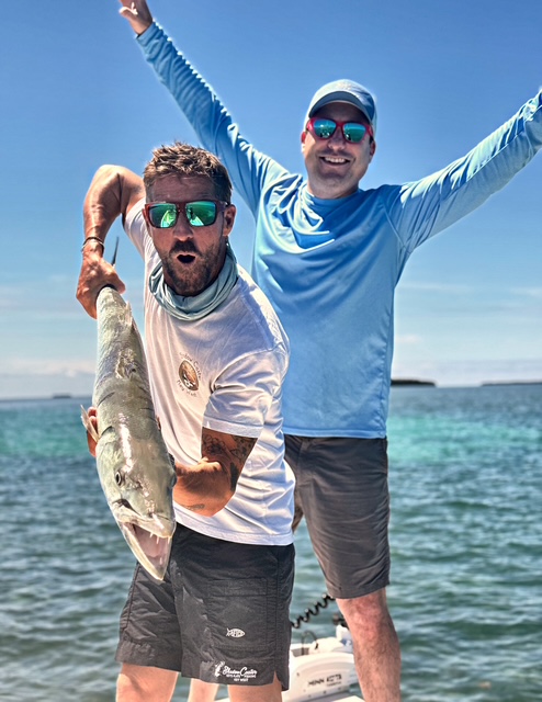 Captain and guest celebrating a catch on a Key West charter