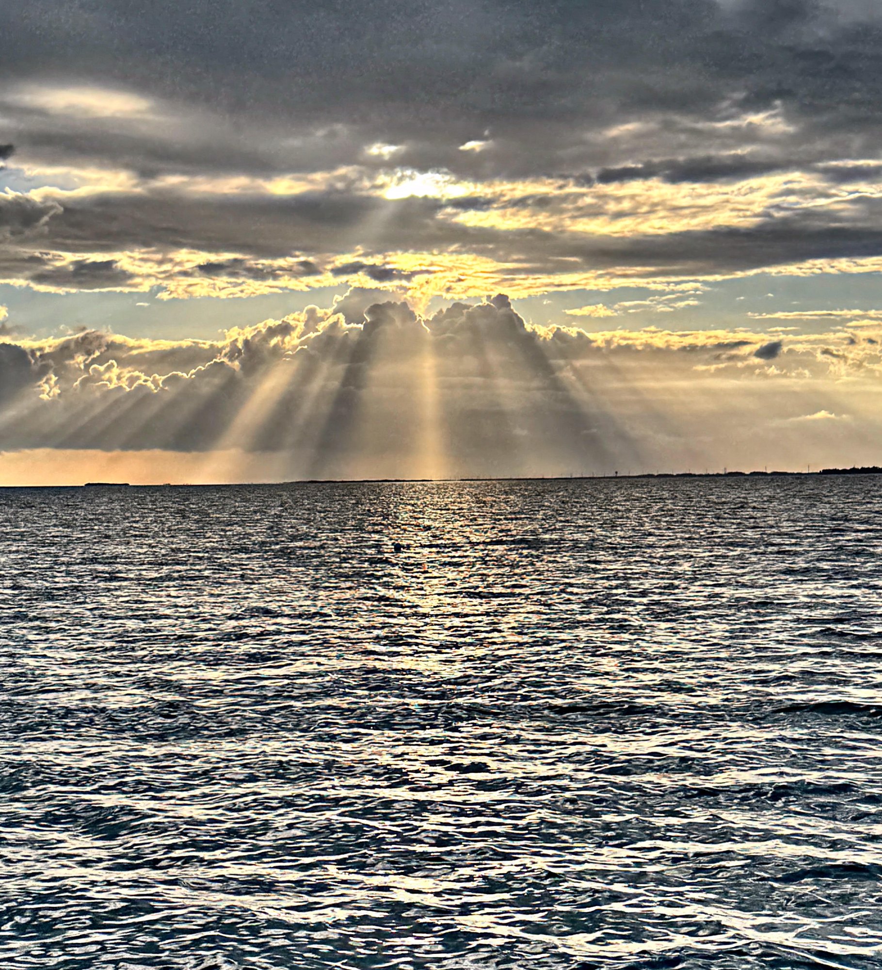 Sun rays breaking through clouds over the Key West backcountry at dawn