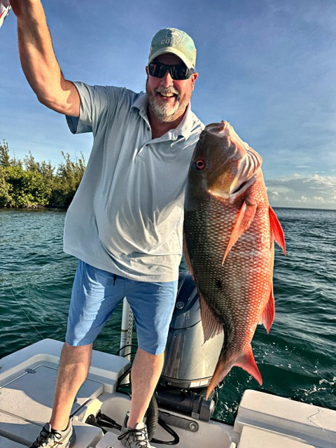Angler holding a large mutton snapper off Key West
