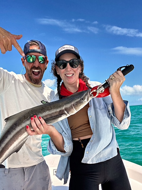 Guest and captain holding a cobia on a Key West charter