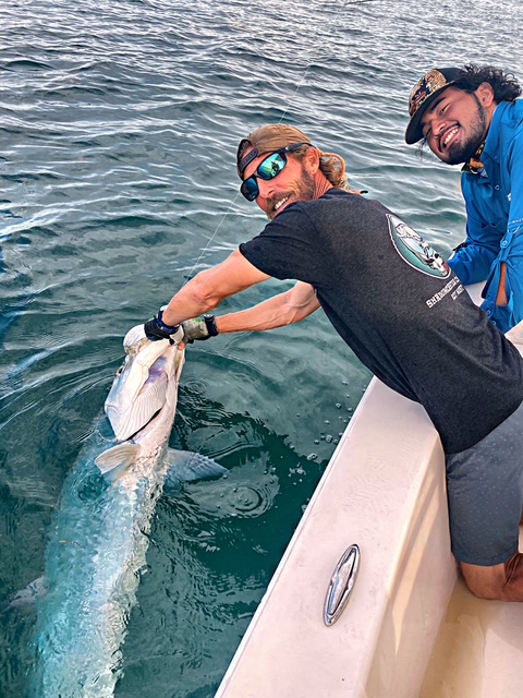 Two anglers posing with a tarpon on a Key West charter boat