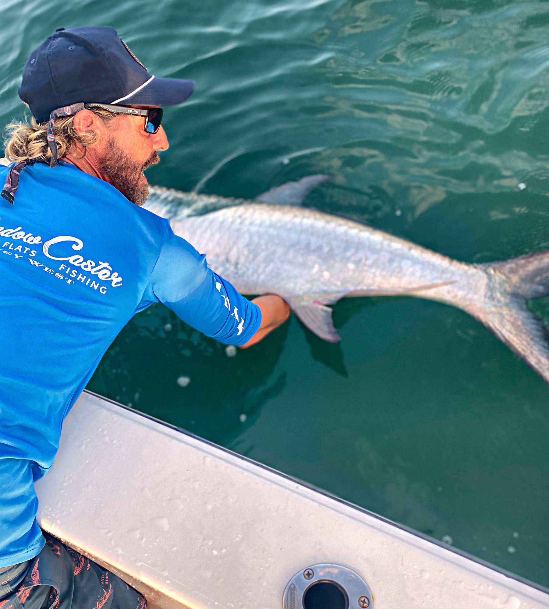 Capt. Juice Valakis releasing a tarpon boatside in Key West