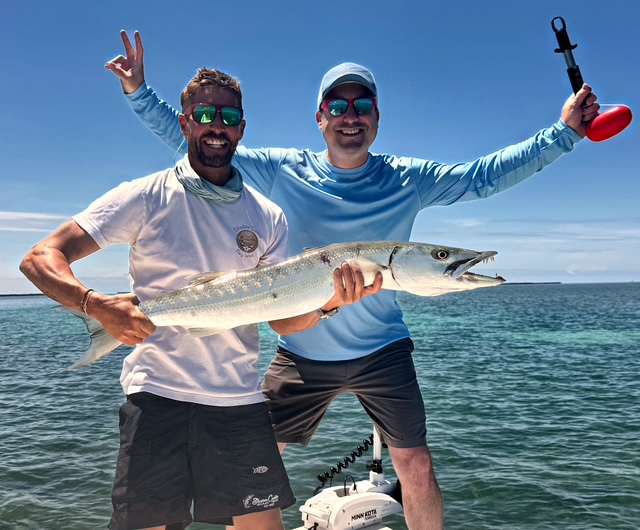 Captain and guest celebrating a big barracuda off Key West