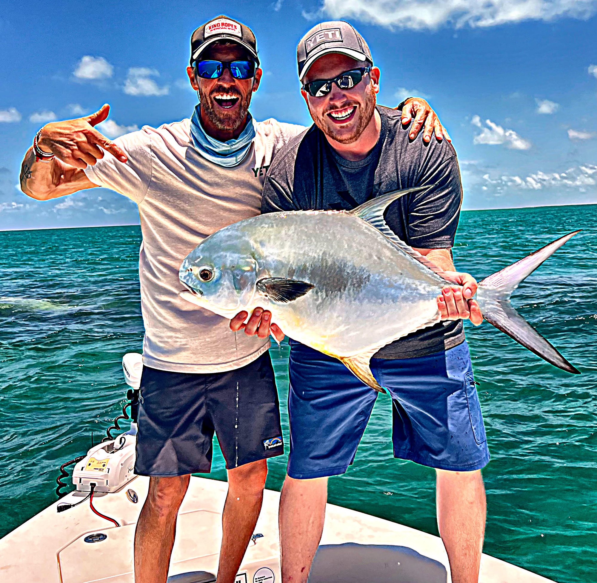 Two anglers on the deck with a permit caught off Key West
