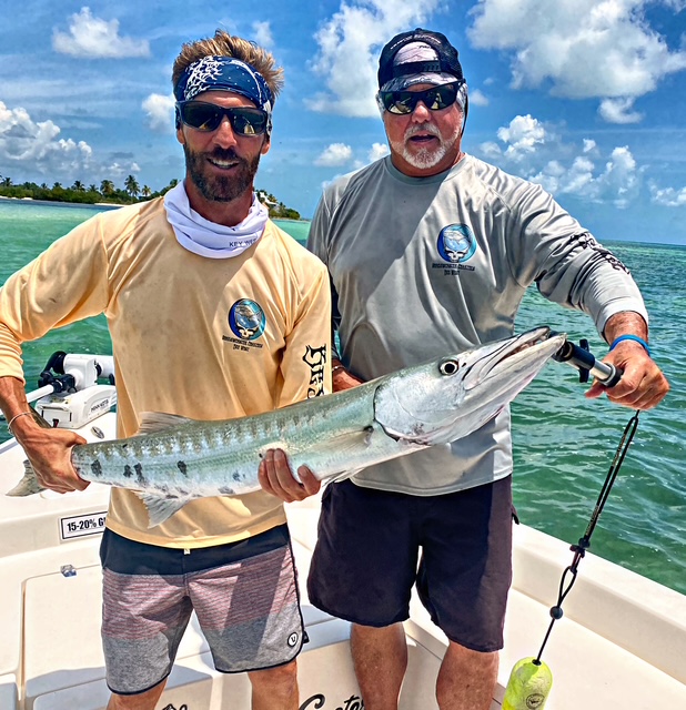 Two anglers with a barracuda on the Key West flats
