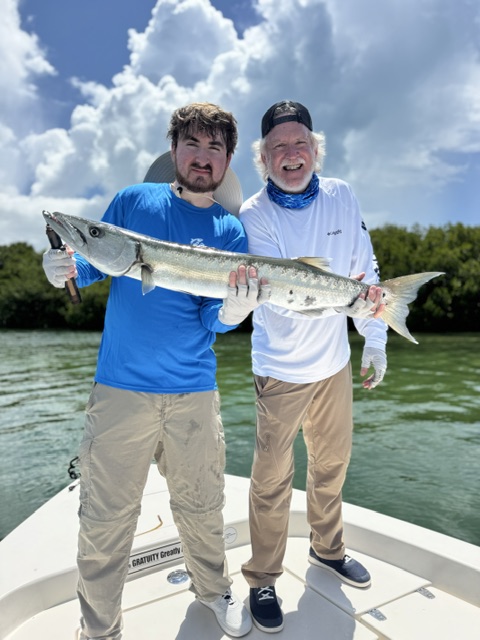 Father and son holding a barracuda on a Key West charter